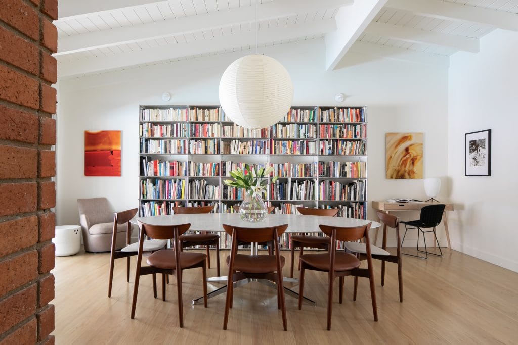 Dining room with a bookshelf by Decorilla designer, Leonora M.
