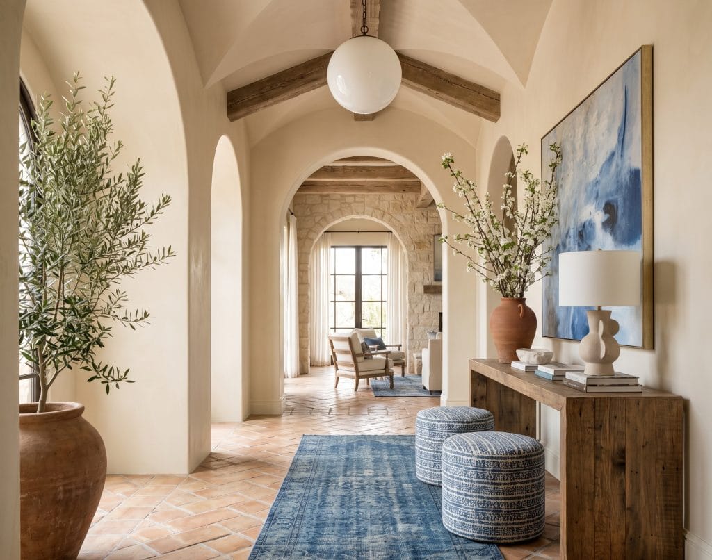 Warm neutral limewash walls in a bright, rustic interior by Decorilla